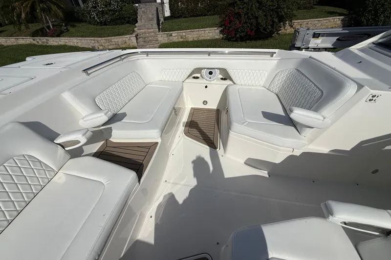 Slide: The Image of Luxurious seating area on a 2021 World Cat 400 DC-X boat, featuring white upholstery. - 12