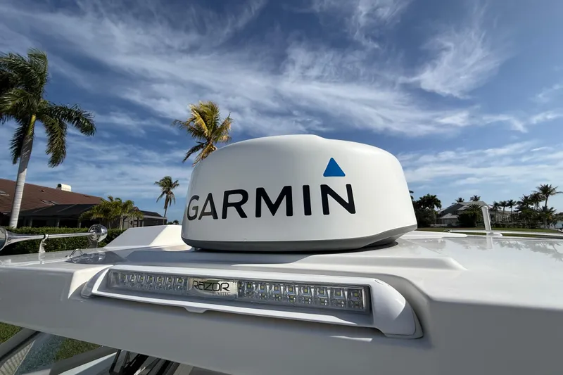 Slide: The Image of Garmin radar on 2021 World Cat 400 DC-X boat under clear blue sky. - 13