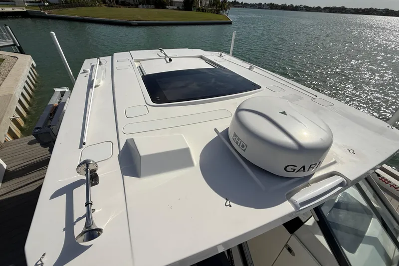 Slide: The Image of 2021 World Cat 400 DC-X boat roof with Garmin radar, docked by water. - 14