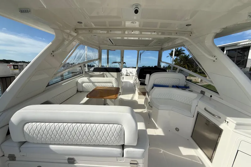 Slide: The Image of Luxurious interior of 2021 World Cat 400 DC-X boat with white seating and wooden table. - 18