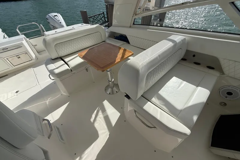 Slide: The Image of Luxurious seating area on 2021 World Cat 400 DC-X boat with elegant white upholstery. - 19