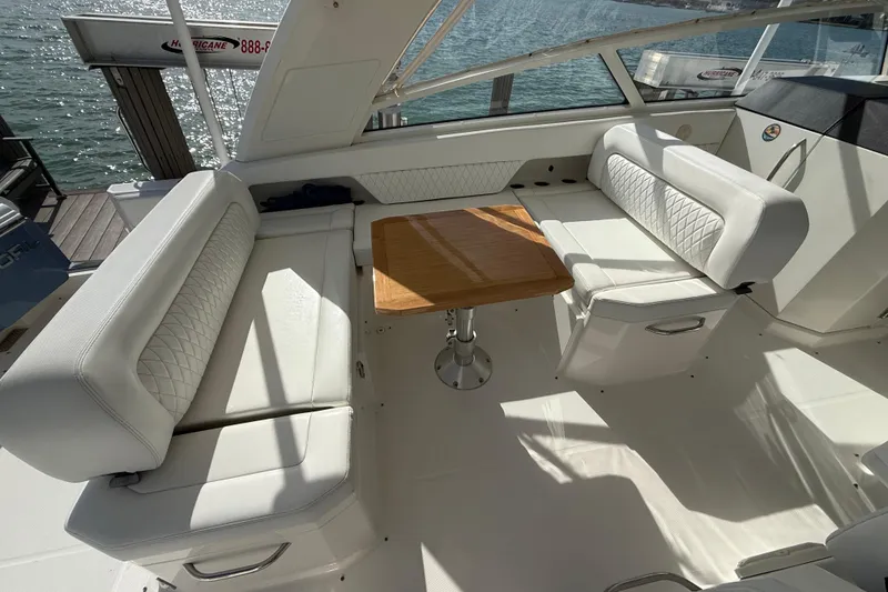 Slide: The Image of Luxurious seating area on 2021 World Cat 400 DC-X boat with wooden table. - 20