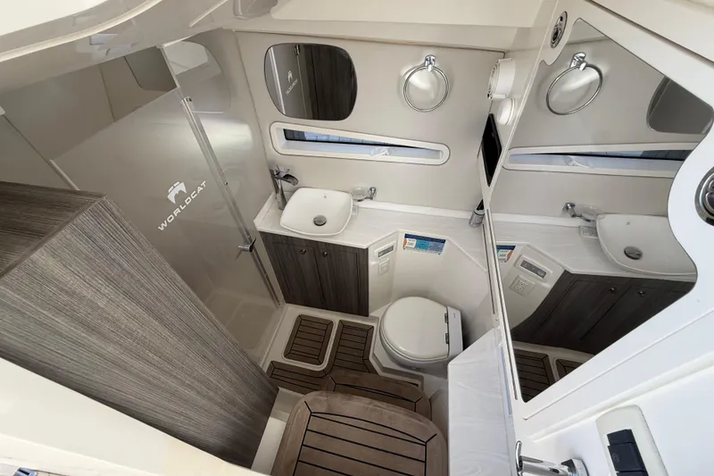 Slide: The Image of Luxurious 2021 World Cat 400 DC-X boat bathroom with modern fixtures and wood accents. - 27