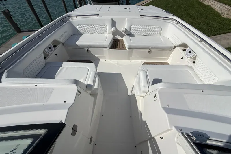 Slide: The Image of Spacious seating area on 2021 World Cat 400 DC-X boat, featuring white cushioned seats. - 28