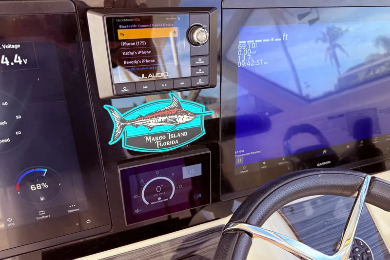 Slide: The Image of Dashboard of 2021 World Cat 400 DC-X boat with navigation and audio controls. - 36