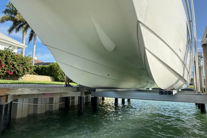 Slide: The Image of World Cat 400 DC-X boat on lift, showcasing sleek hull design, 2021 model. - 39