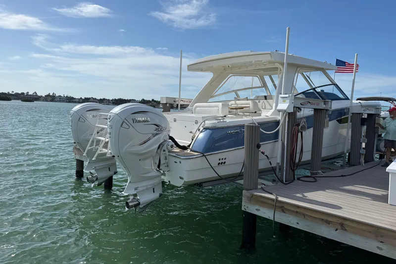 Slide: The Image of 2021 World Cat 400 DC-X boat docked with twin Yamaha engines, American flag visible. - 5