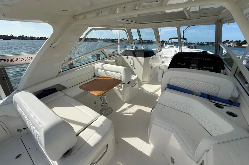 Slide: The Image of Luxurious 2021 World Cat 400 DC-X boat interior with white seating and wooden table. - 6