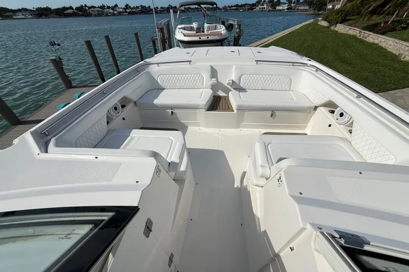 Slide: The Image of Spacious seating area on a 2021 World Cat 400 DC-X boat docked by the water. - 7