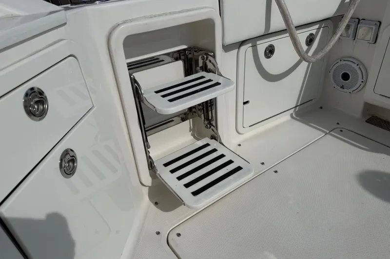 Slide: The Image of 2021 World Cat 400 DC-X boat interior with foldable steps and storage compartments. - 8
