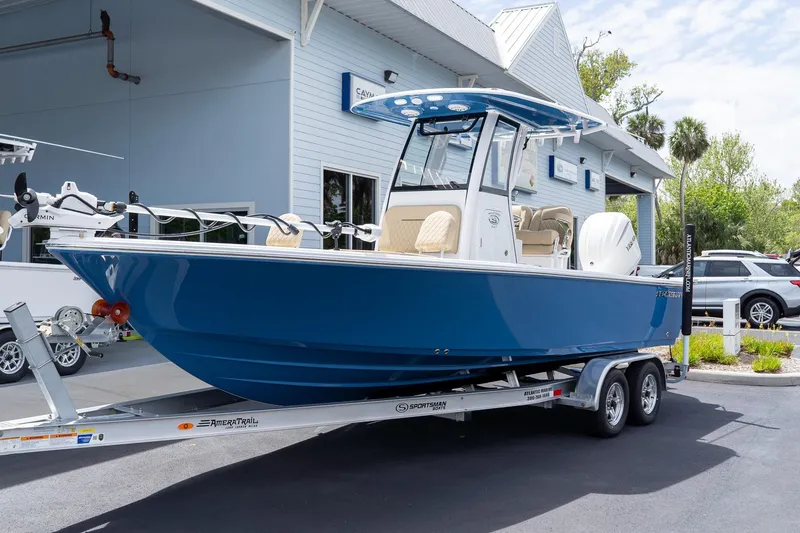 The Image of 2026 Sportsman Masters 247 Bay Boat in blue on trailer outside dealership. - 0