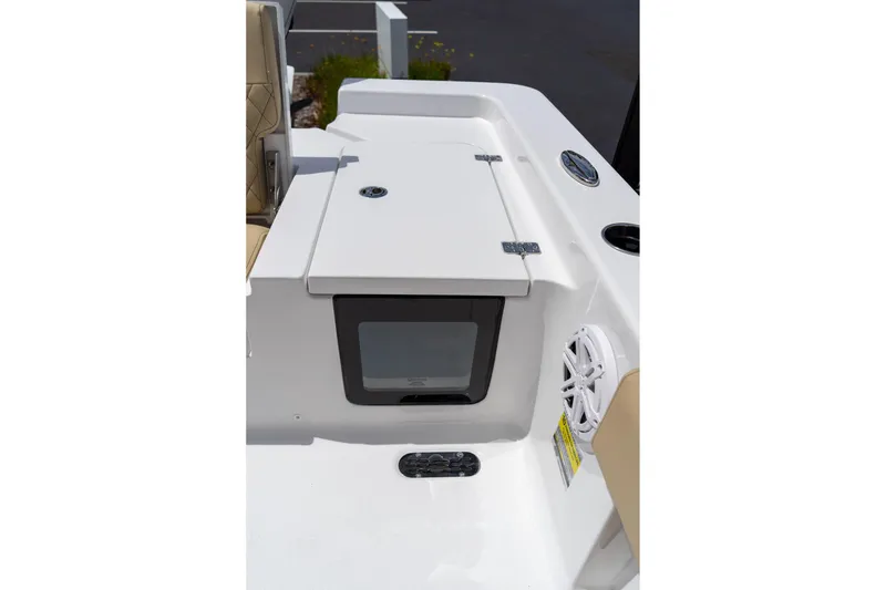 Slide: The Image of 2026 Sportsman Masters 247 Bay Boat interior with storage compartment and speaker. - 15