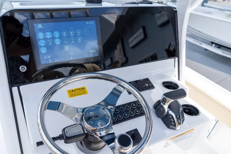 Slide: The Image of 2026 Sportsman Masters 247 Bay Boat dashboard with touchscreen and steering wheel. - 20
