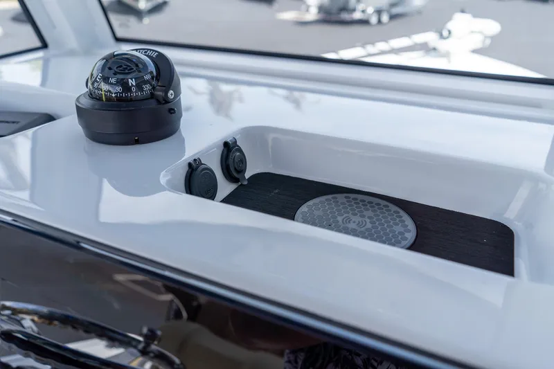 Slide: The Image of Compass and charging station on 2026 Sportsman Masters 247 Bay Boat dashboard. - 21