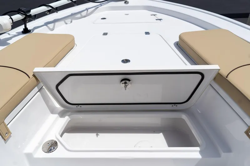 Slide: The Image of 2026 Sportsman Masters 247 Bay Boat storage compartment with beige seating. - 25