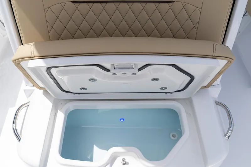 Slide: The Image of Livewell compartment on 2026 Sportsman Masters 247 Bay Boat, featuring cushioned seating. - 29