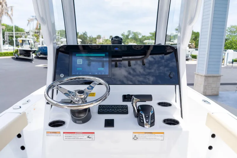 Slide: The Image of 2026 Sportsman Masters 247 Bay Boat dashboard with steering wheel and digital display. - 38