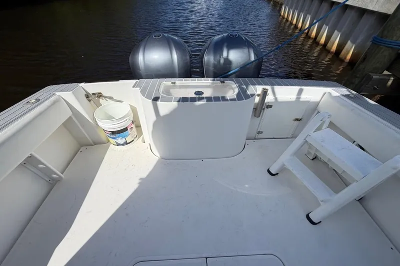 Slide: The Image of 2006 Contender 35 Side Console boat deck with twin engines and fishing gear. - 10