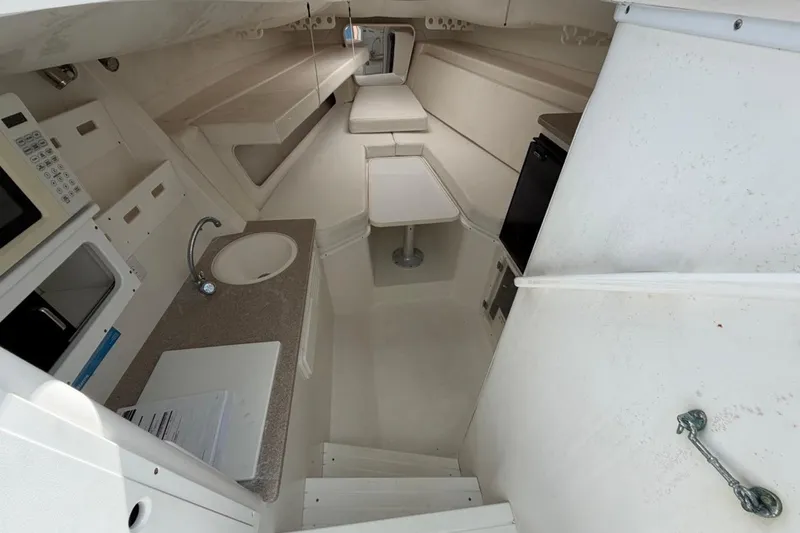 Slide: The Image of 2006 Contender 35 Side Console interior with kitchenette, sink, and seating area. - 11