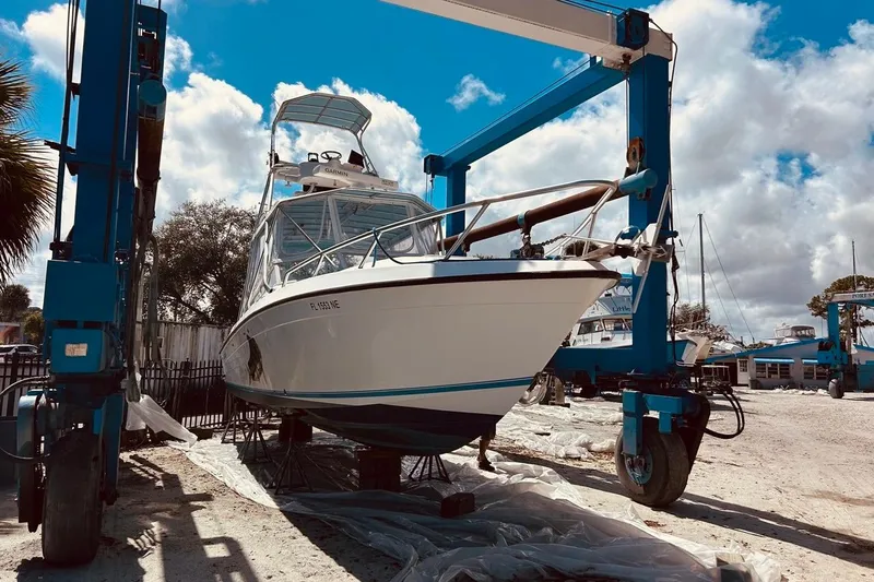 Slide: The Image of 2006 Contender 35 Side Console boat in dry dock under blue sky. - 2