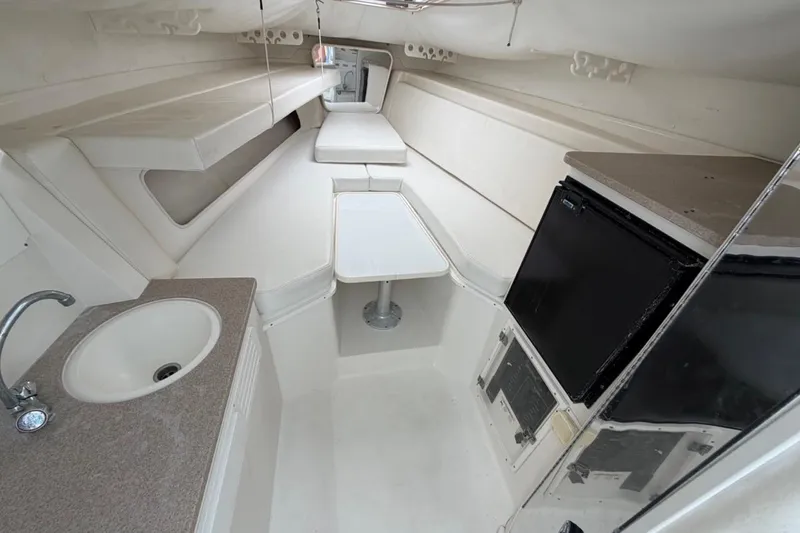 Slide: The Image of 2006 Contender 35 Side Console interior with sink, table, and compact fridge. - 3
