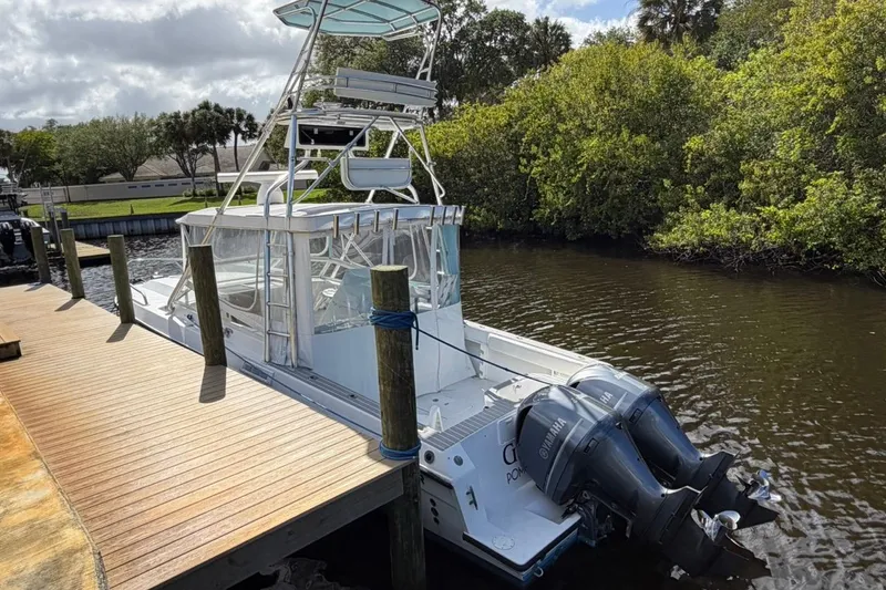 Slide: The Image of 2006 Contender 35 Side Console boat docked with dual Yamaha outboard engines. - 5