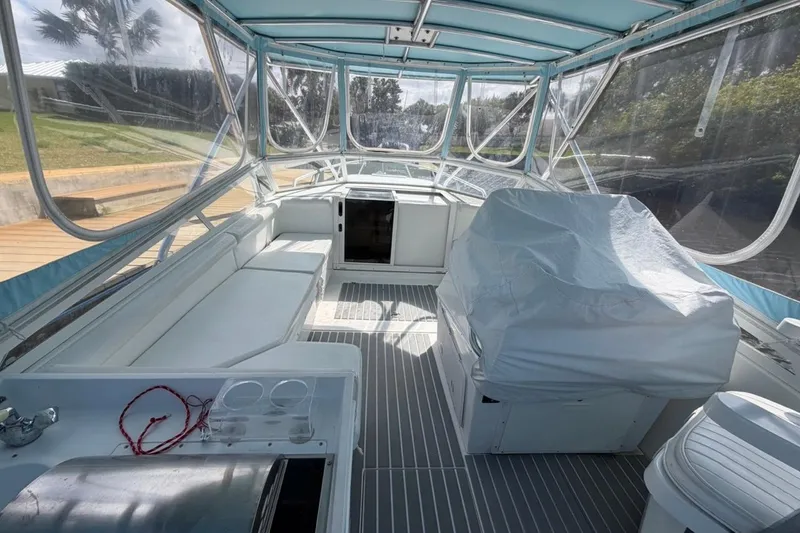 Slide: The Image of 2006 Contender 35 Side Console boat interior with seating and covered helm. - 7