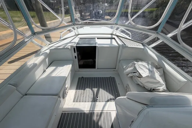 Slide: The Image of 2006 Contender 35 Side Console boat interior with seating and covered windows. - 9