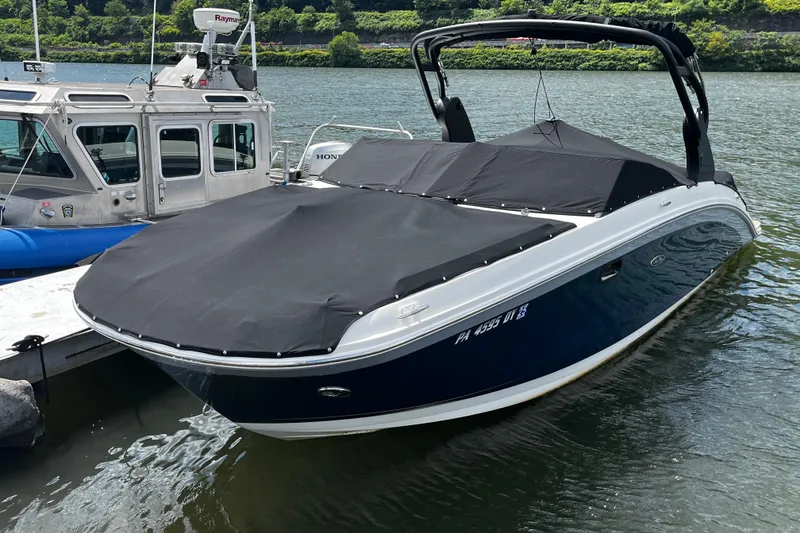 The Image of 2019 Sea Ray SDX 270 boat docked with black cover on a sunny day. - 0