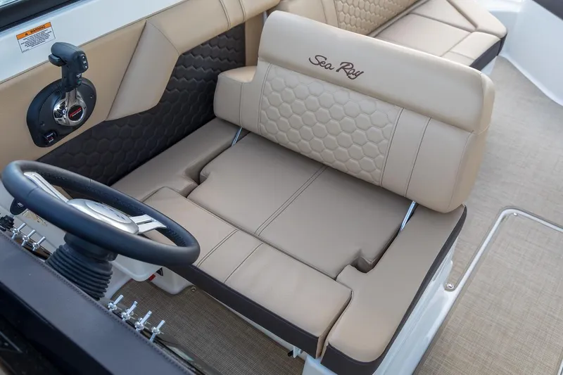 Slide: The Image of Manufacturer Provided Image: 2019 Sea Ray SDX 270 boat interior with beige seating and steering wheel. - 12