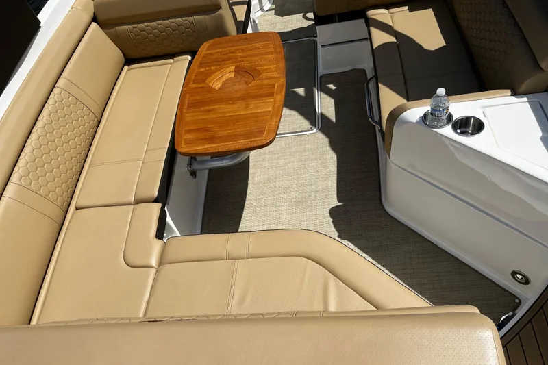 Slide: The Image of Luxurious seating area on a 2019 Sea Ray SDX 270 boat with wooden table. - 22