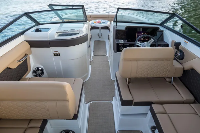 Slide: The Image of 2019 Sea Ray SDX 270 boat interior with beige seating and wooden table. - 8