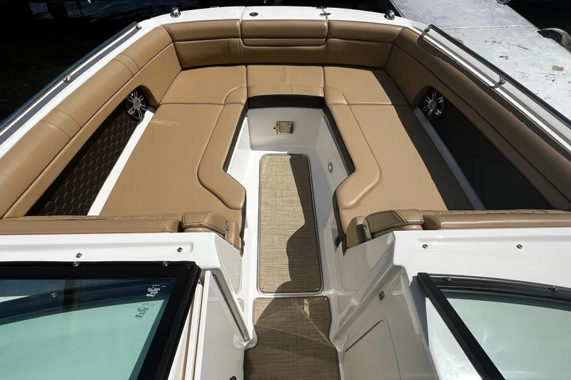 Slide: The Image of 2019 Sea Ray SDX 270 boat interior with tan seating and spacious layout. - 9