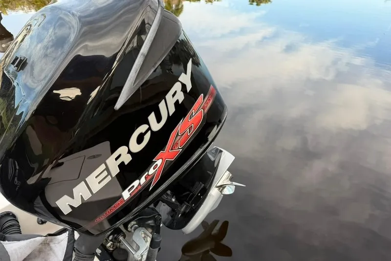 Slide: The Image of Mercury Pro XS outboard motor on 2008 Maverick 21 Master Angler boat, reflecting on water. - 11