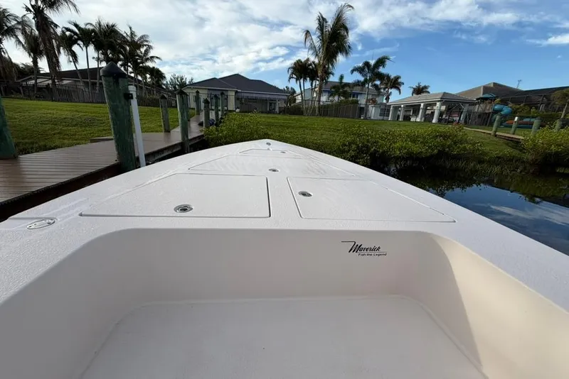 Slide: The Image of 2008 Maverick 21 Master Angler boat docked near lush greenery and palm trees. - 3