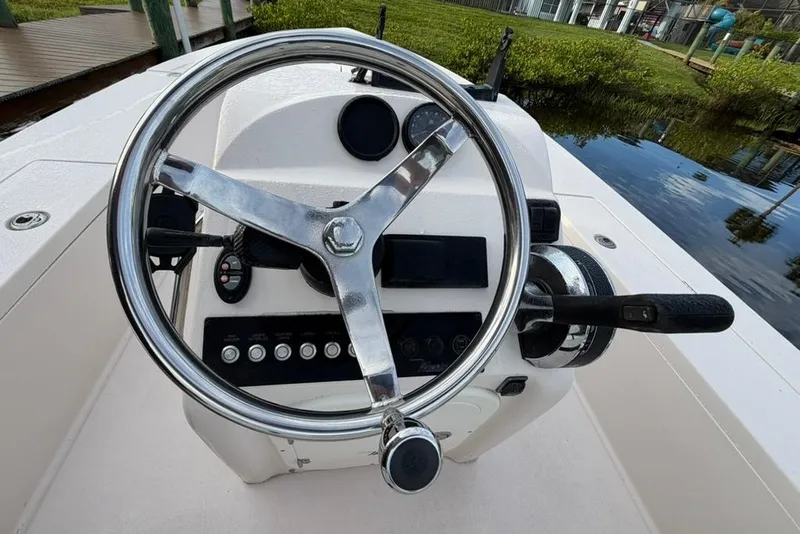 Slide: The Image of Steering console of a 2008 Maverick 21 Master Angler boat, featuring a chrome wheel. - 4