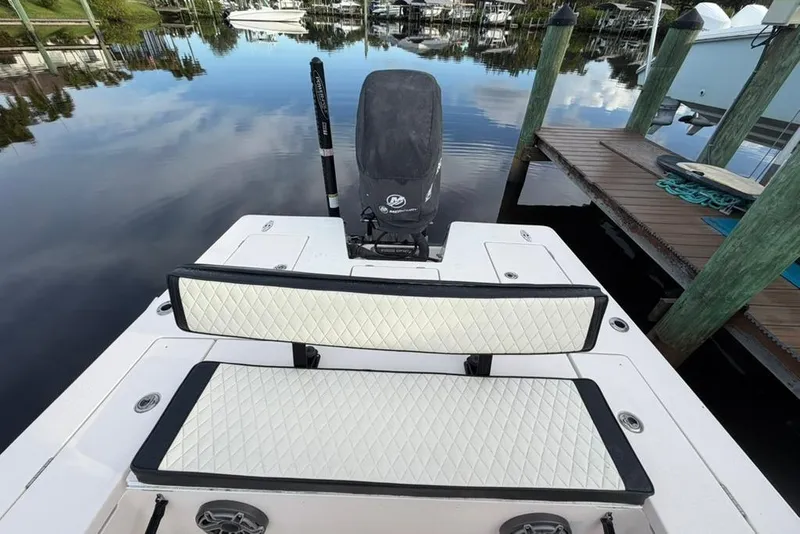 Slide: The Image of 2008 Maverick 21 Master Angler boat with cushioned seating and outboard motor at dock. - 6