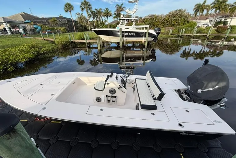 Slide: The Image of 2008 Maverick 21 Master Angler boat docked on calm water with Mercury engine. - 7