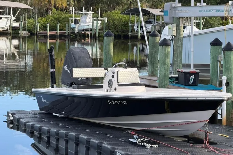 Slide: The Image of 2008 Maverick 21 Master Angler boat docked at a marina with lush greenery. - 9