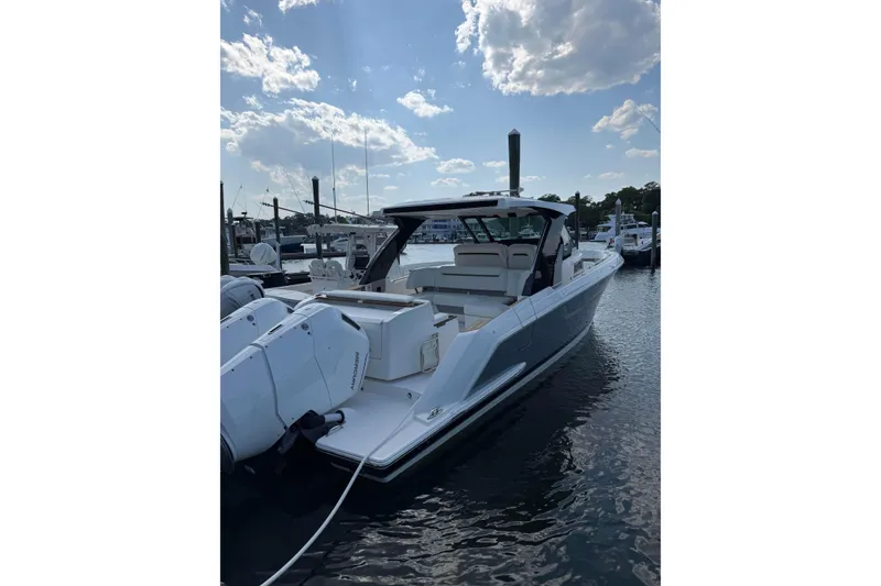 Slide: The Image of 2026 Tiara Yachts 39 LS luxury boat docked under a partly cloudy sky. - 11