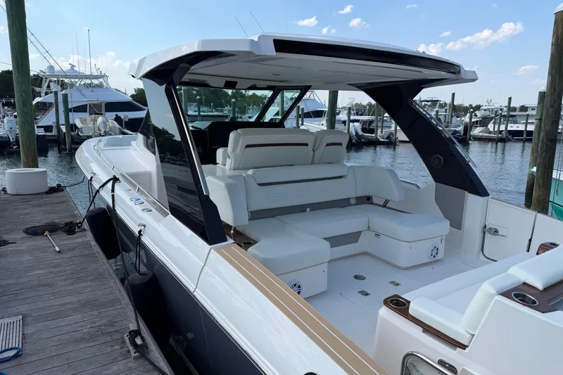 Slide: The Image of 2026 Tiara Yachts 39 LS luxury boat docked at marina, featuring spacious seating. - 9