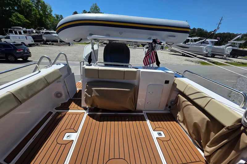 Slide: The Image of 2025 Ranger Tugs R-25 boat deck with seating and inflatable dinghy. - 10
