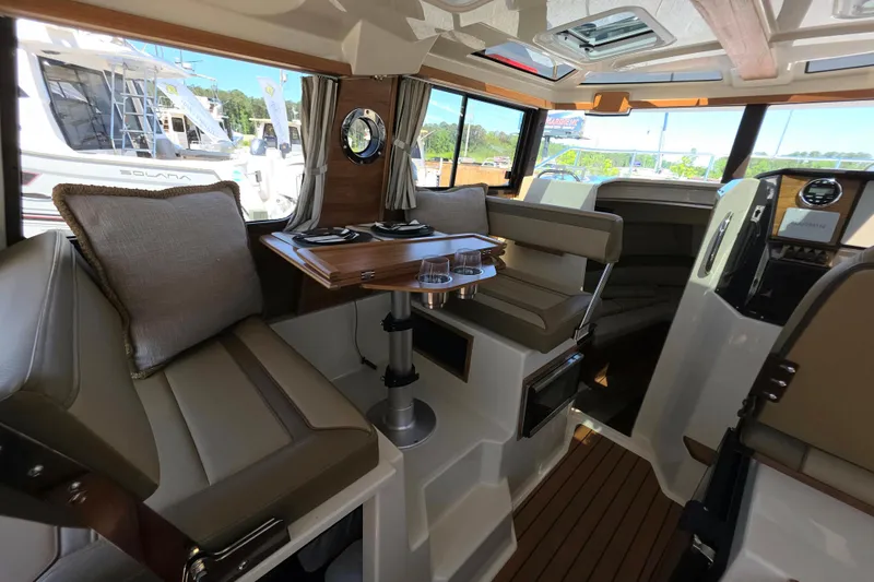 Slide: The Image of Interior of 2025 Ranger Tugs R-25, featuring seating and dining area with modern design. - 19