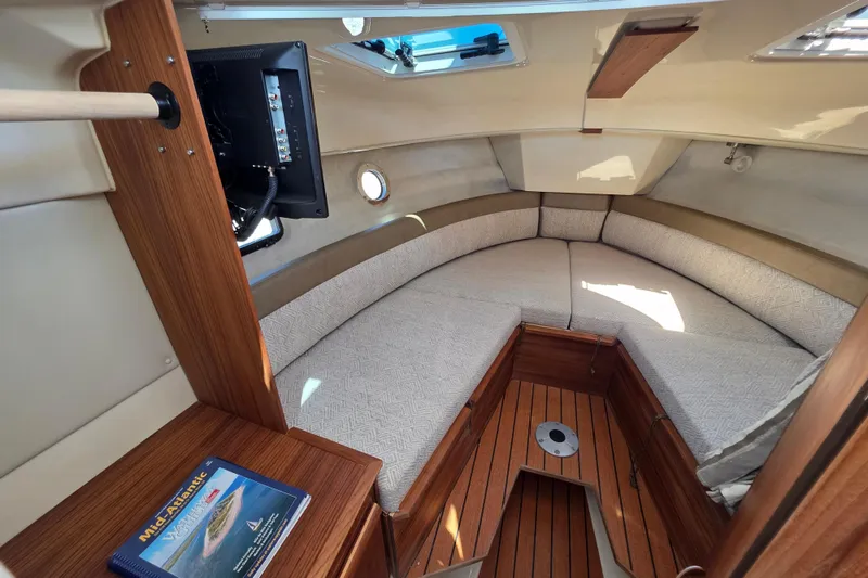 Slide: The Image of Cozy interior of 2025 Ranger Tugs R-25 boat with wood accents and seating area. - 23