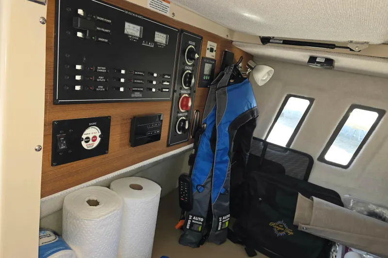 Slide: The Image of Interior of 2025 Ranger Tugs R-25 showing control panel and storage area. - 25