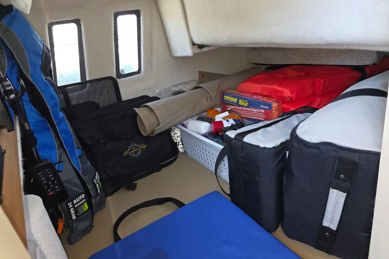 Slide: The Image of Interior storage of 2025 Ranger Tugs R-25 boat with safety gear and equipment. - 26