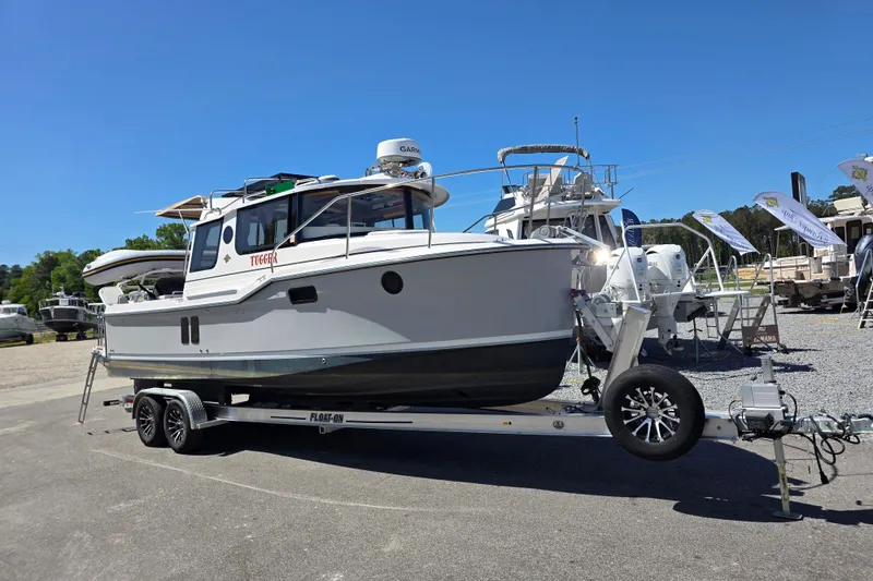 Slide: The Image of 2025 Ranger Tugs R-25 boat on trailer at outdoor display. - 3