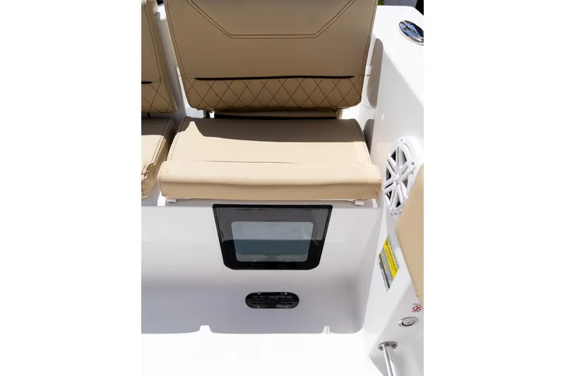 Slide: The Image of 2026 Sportsman Heritage 231 Center Console boat seat with beige upholstery and storage compartment. - 15
