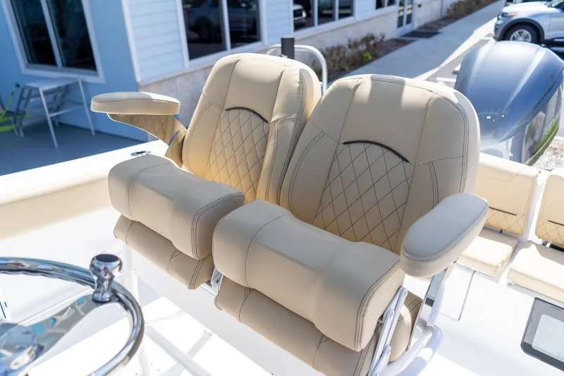 Slide: The Image of Luxurious seating on 2026 Sportsman Heritage 231 Center Console boat, featuring beige upholstery. - 17