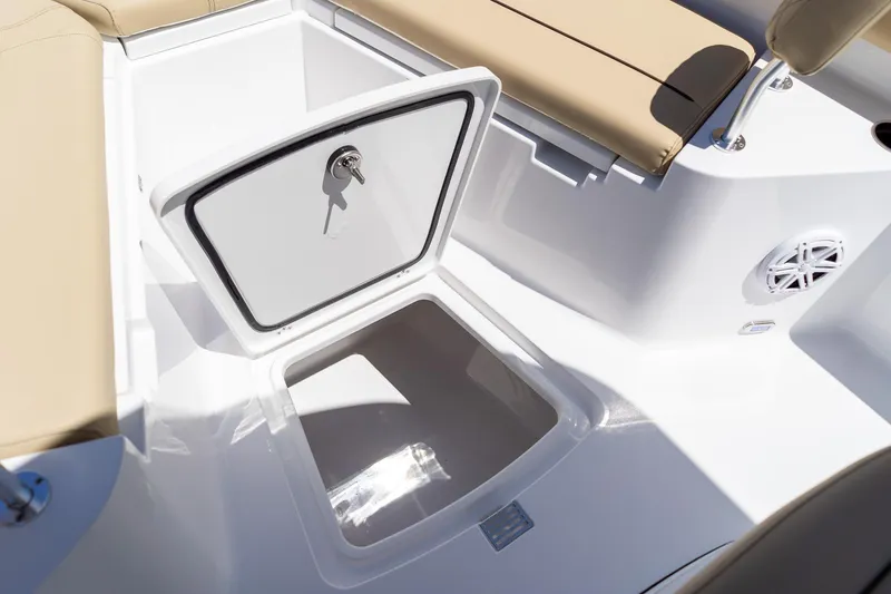 Slide: The Image of 2026 Sportsman Heritage 231 Center Console boat storage compartment with beige seating. - 22